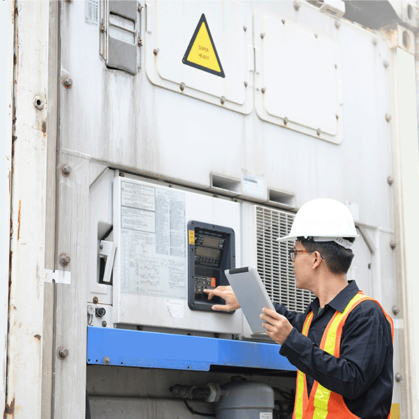 Worker adjusting temperature on a refrigerated container.