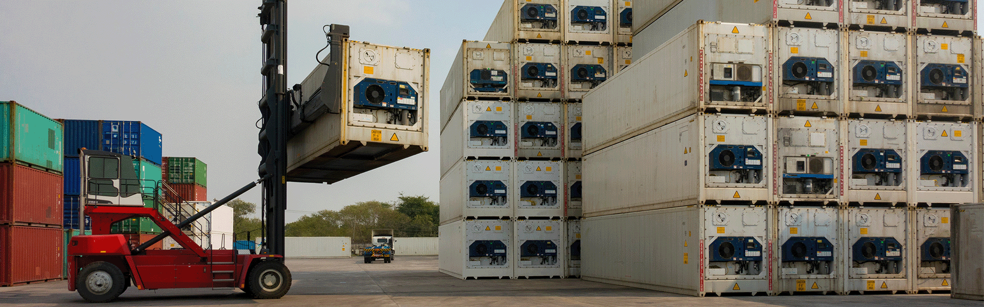 Reefer containers being loaded by forklift