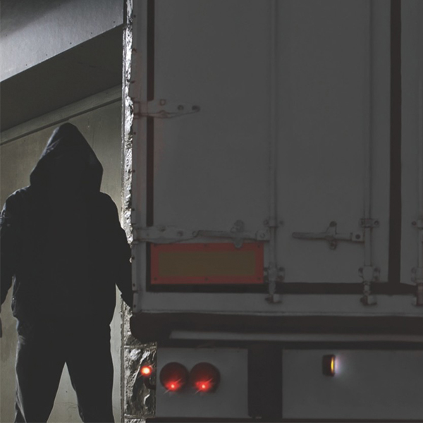 Man in dark clothes with a freight truck