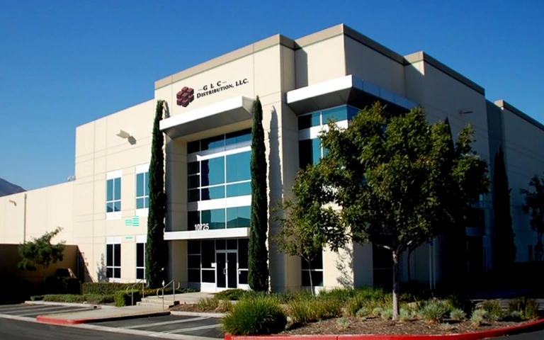 Exterior of the GLC Distribution warehouse facility in Fontana, California, under a clear blue sky.